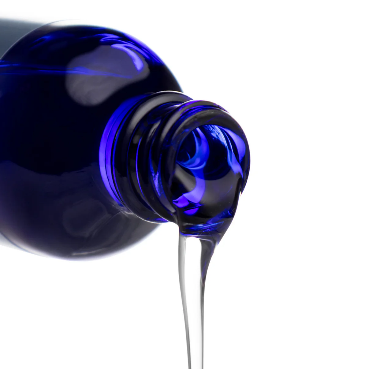 Blue bottle pouring clear liquid