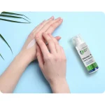 BeSerene IR cream being applied to the back of the hand, with the pump bottle beside it