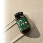 Lithium Orotate bottle by Global Healing lying on sand, 60 capsules, 10 mg bioavailable lithium