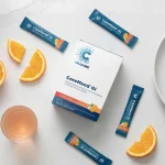CoreMend GI box and stick packs with orange slices on a kitchen bench