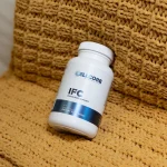 IFC bottle resting on a knitted yellow blanket